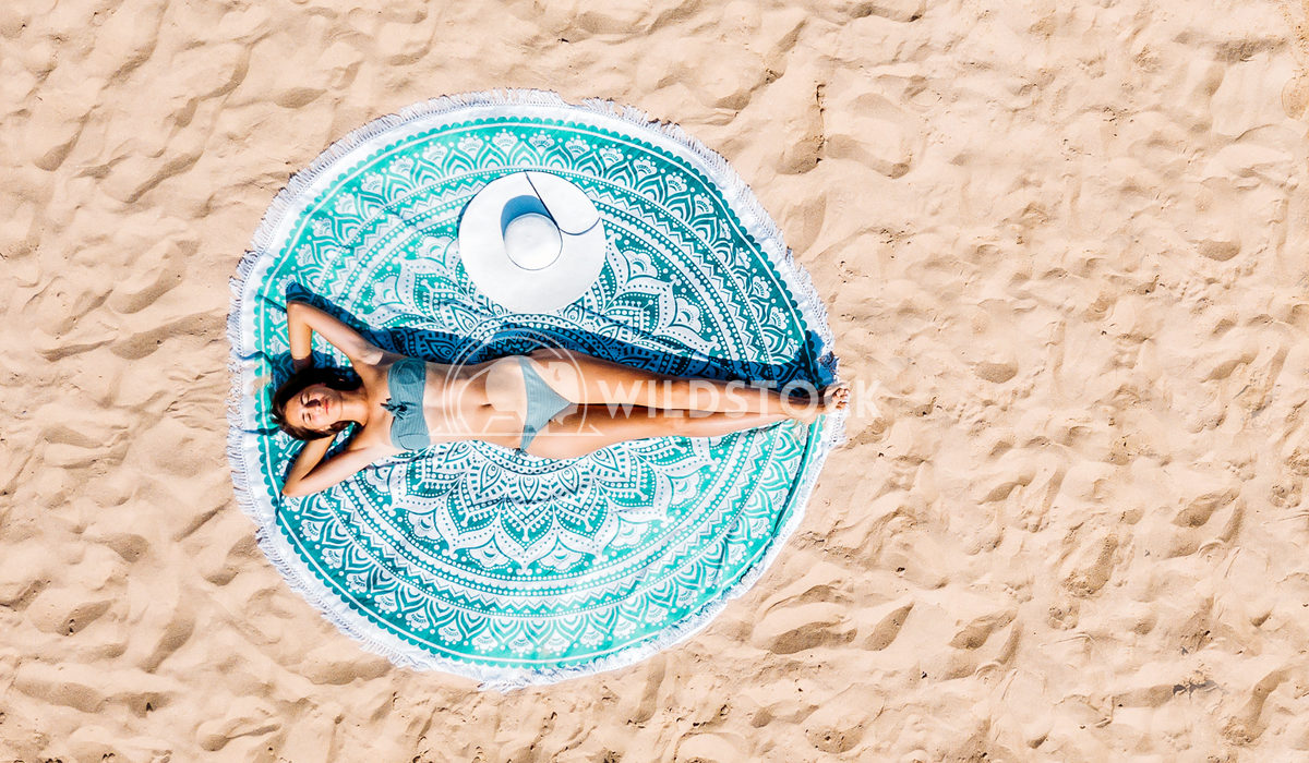 Top Aerial Drone View Of Woman In Swimsuit Relaxing And Sunbathing On Round Turquoise Beach Towel Near The Ocean Radu Be